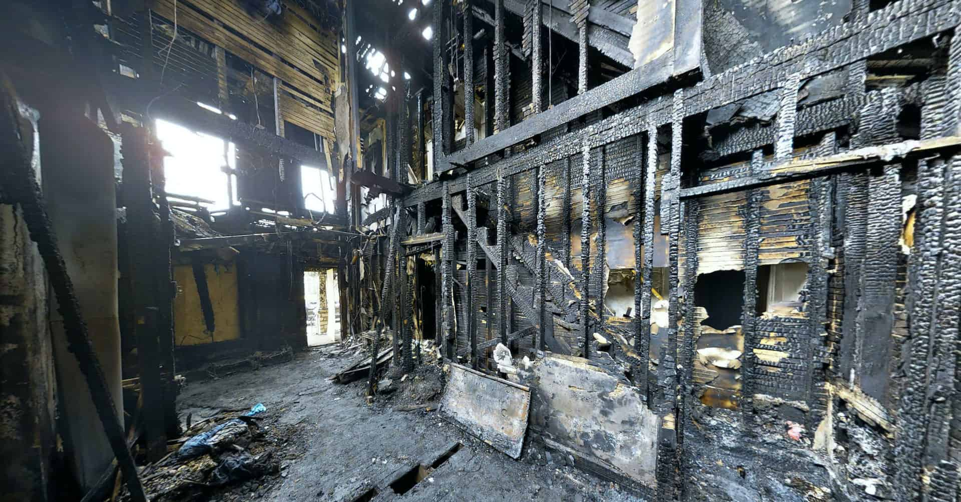 Charred remains of the inside of a house.